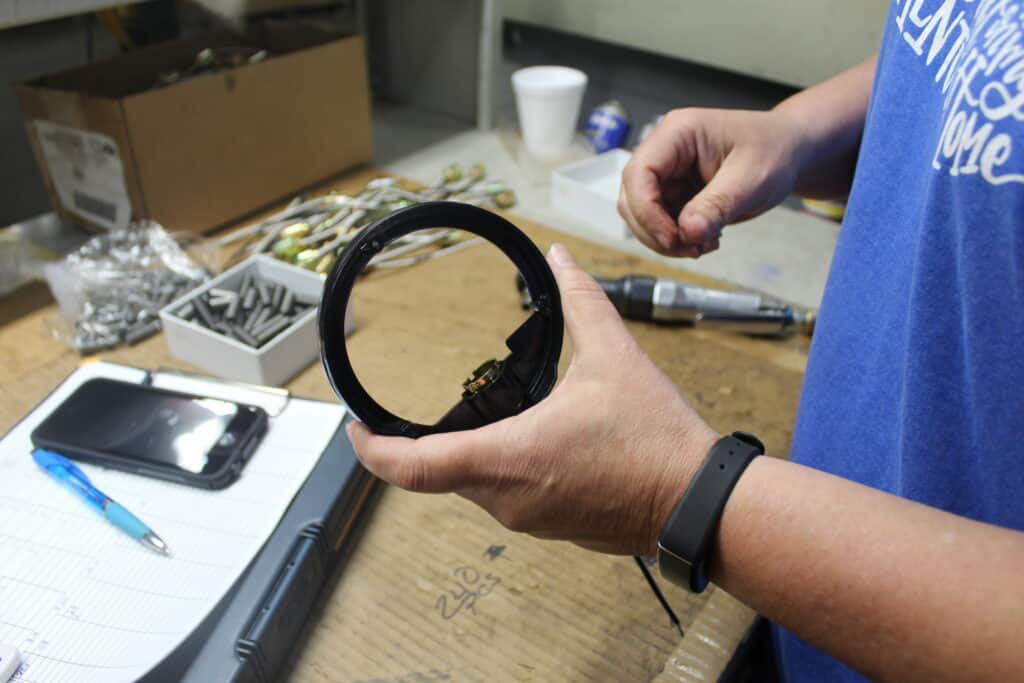 Man holding a plastic part that was created using custom injection molding