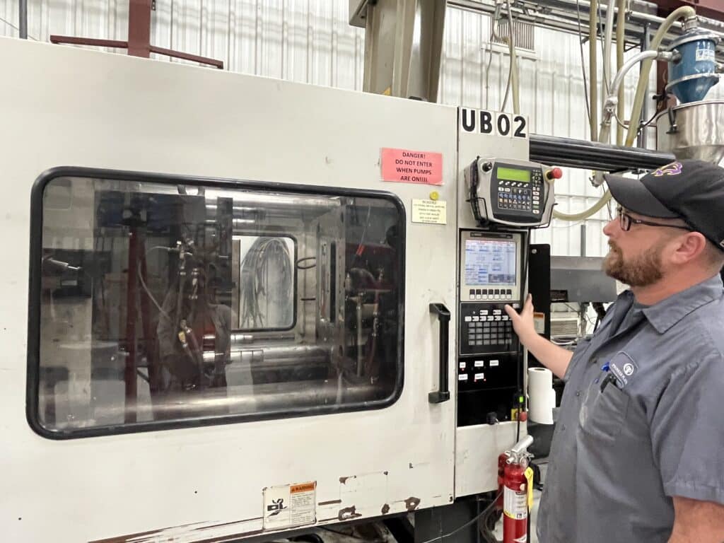 Pioneer Worker opening custom injection molding machine