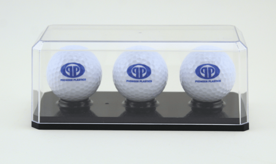 Display case featuring three branded golf balls for collectors and enthusiasts.
