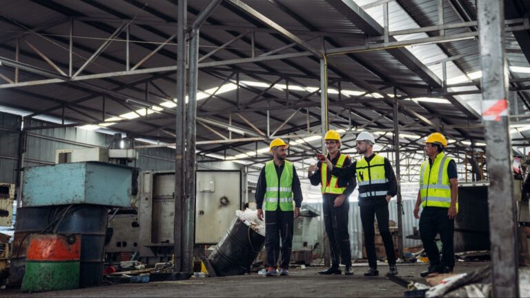 Construction team discussing project plans at a busy site.