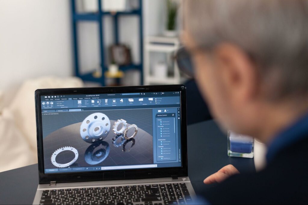 Close-up of 3D design software showcasing intricate mechanical components on a laptop screen.