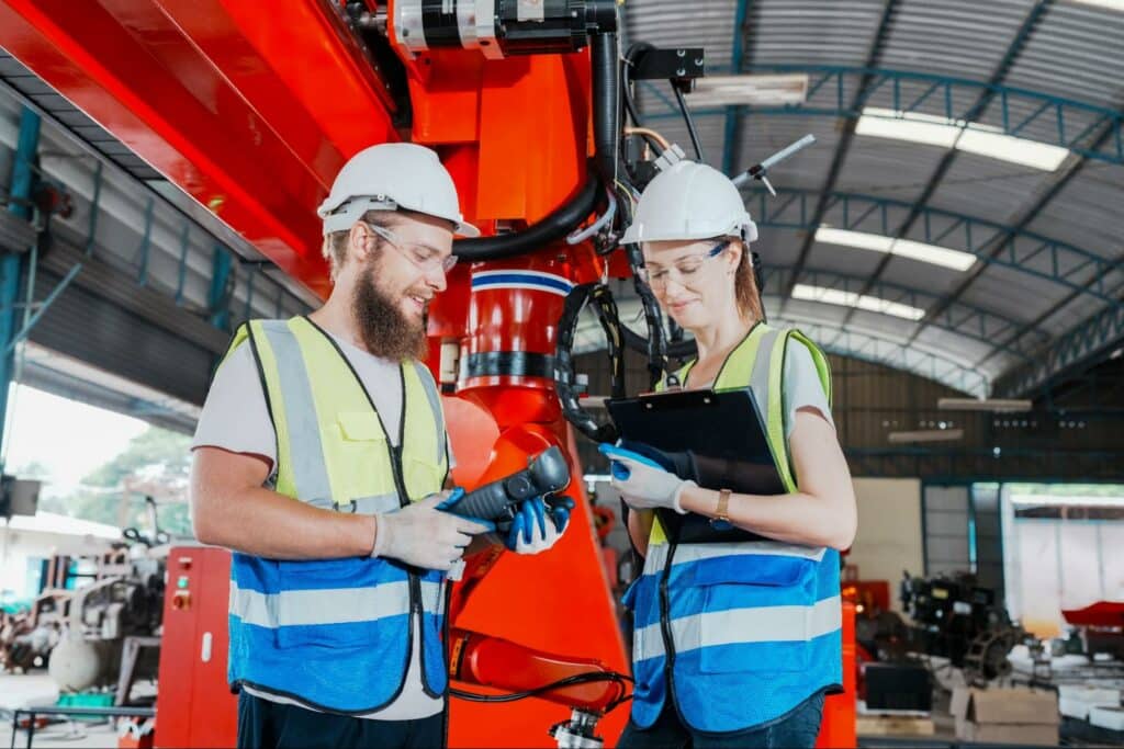 Workers inspecting safety equipment in a manufacturing facility for optimal performance.