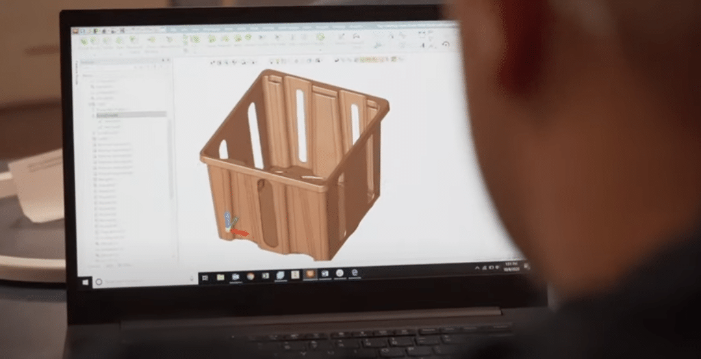 Innovative storage design displayed on a laptop screen, featuring a 3D model of a crate.