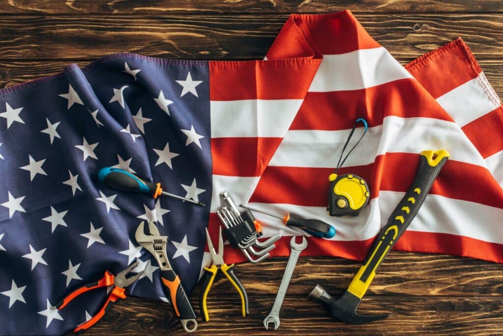 Tools arranged on an American flag, symbolizing patriotism and craftsmanship.