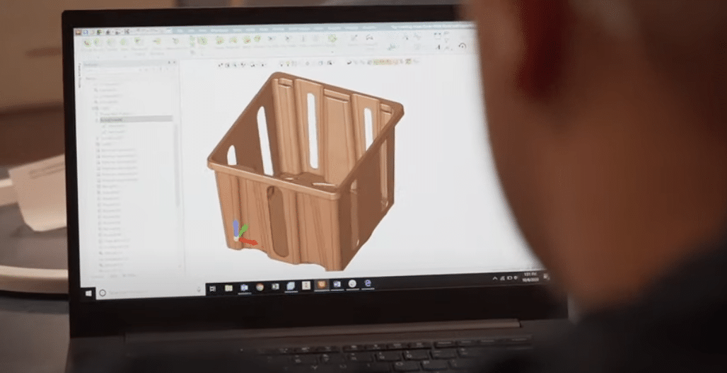 Innovative storage design displayed on a laptop screen, featuring a 3D model of a crate.