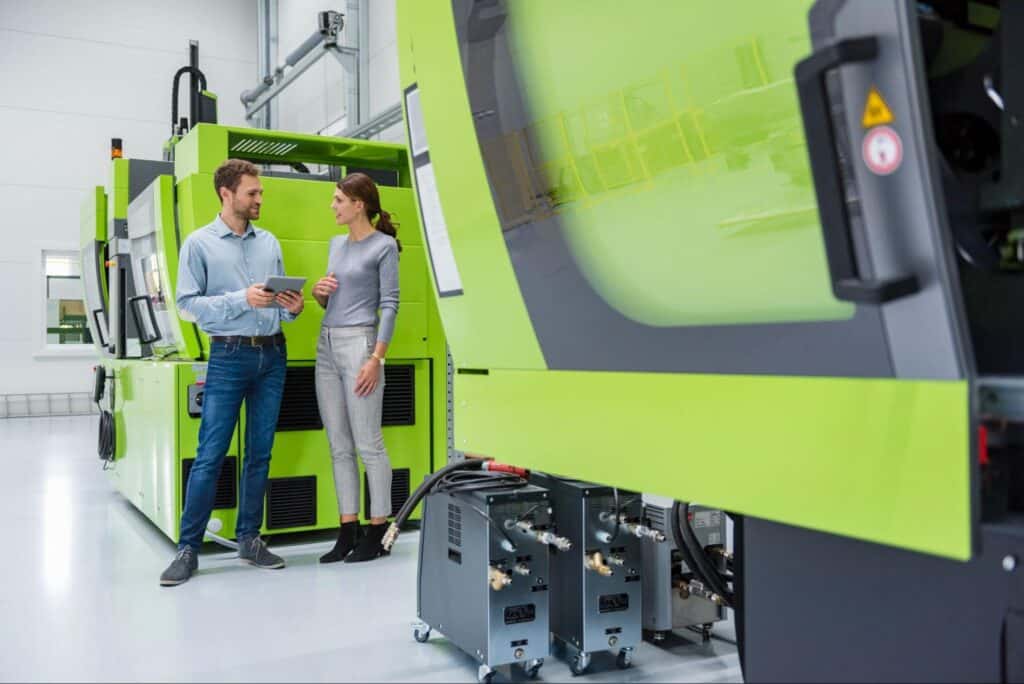 Professionals discussing innovative manufacturing solutions in a modern facility.
