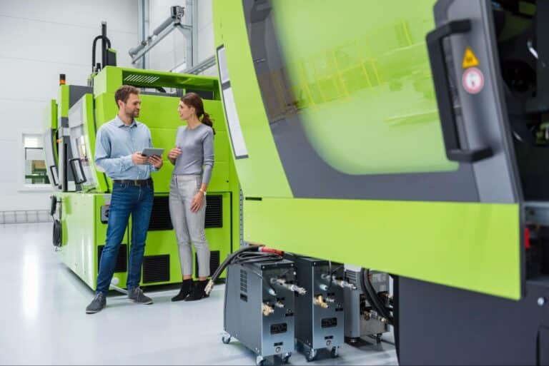 Professionals discussing innovative manufacturing solutions in a modern facility.