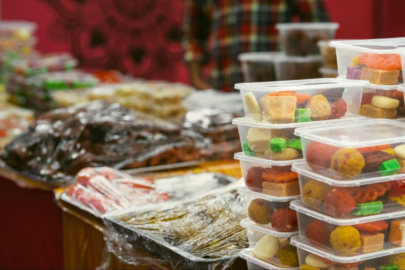 Vibrant market treats displayed in colorful containers, showcasing delicious local snacks.