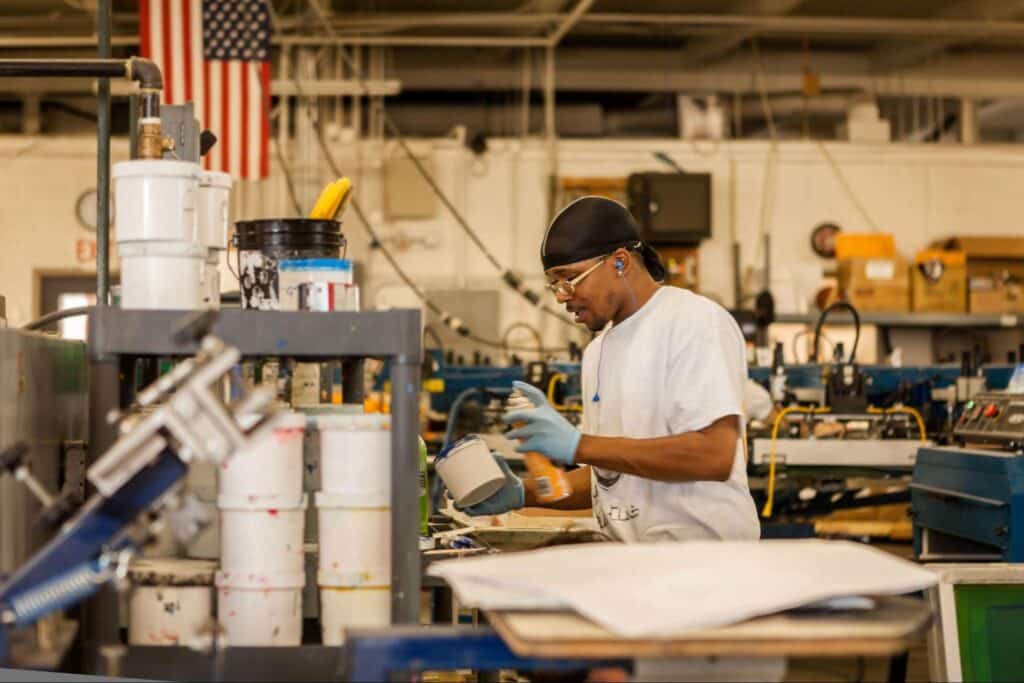 Reshoring manufacturing to U.S. concept with dedicated factory worker focused on quality control.